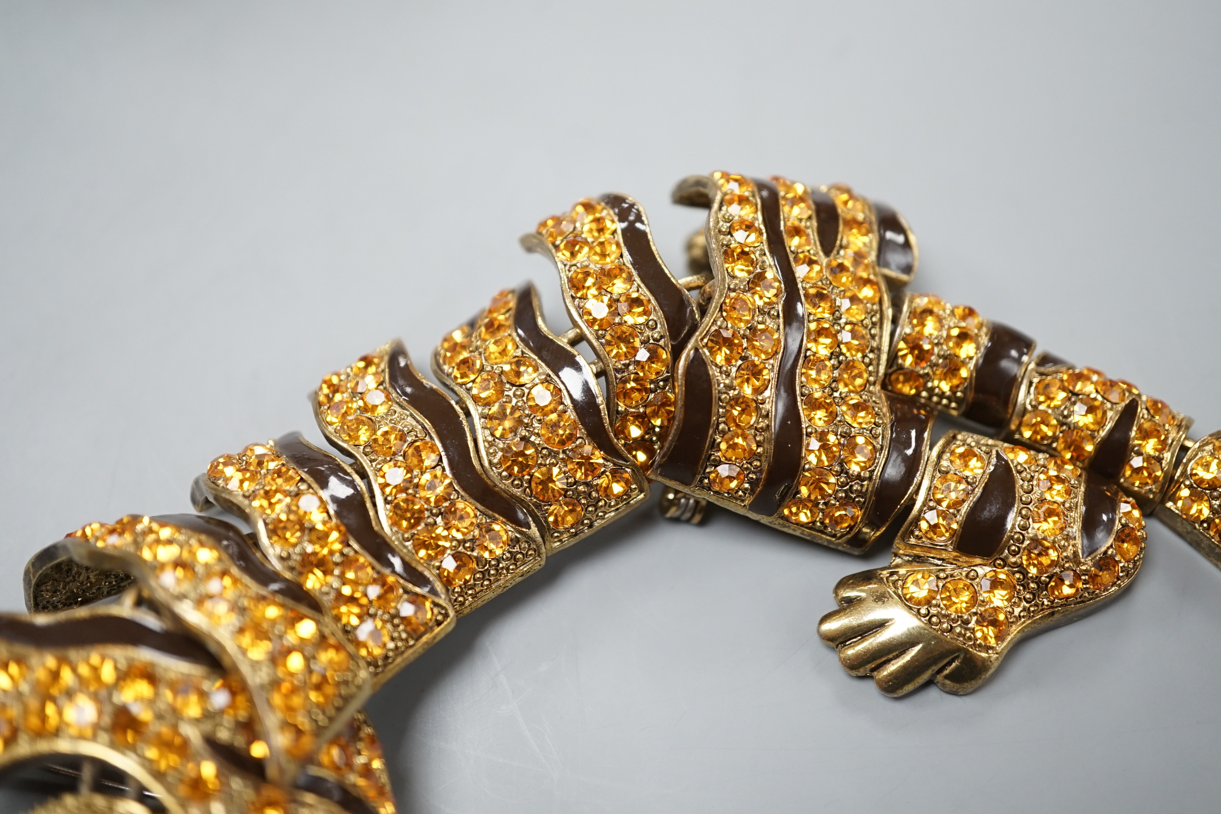 A costume gilt metal and paste set tiger shoulder? ornament, 24.5cm.